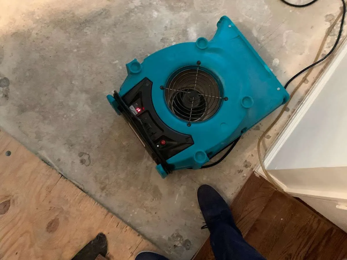 Air mover drying subfloor during Commercial Water Damage Restoration in Bulverde